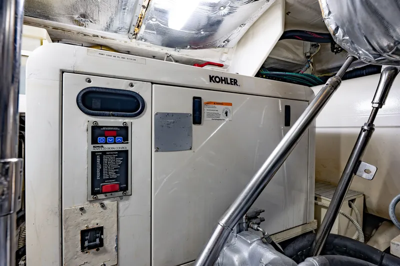 Slide: The Image of Engine room of a 2010 Pershing 80 yacht featuring a Kohler generator. - 102