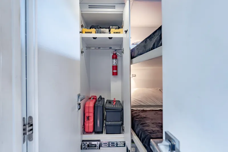 Slide: The Image of Storage area with tools and bunk beds on a 2010 Pershing 80 yacht. - 88