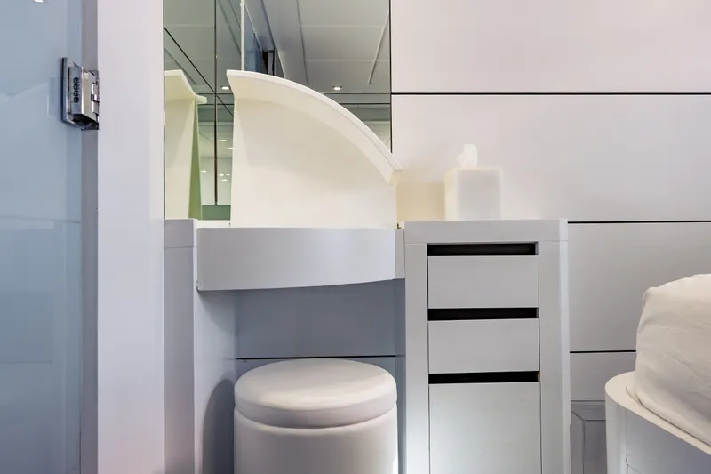 Slide: The Image of Modern bathroom interior on a 2010 Pershing 80 yacht, featuring sleek white cabinetry. - 56