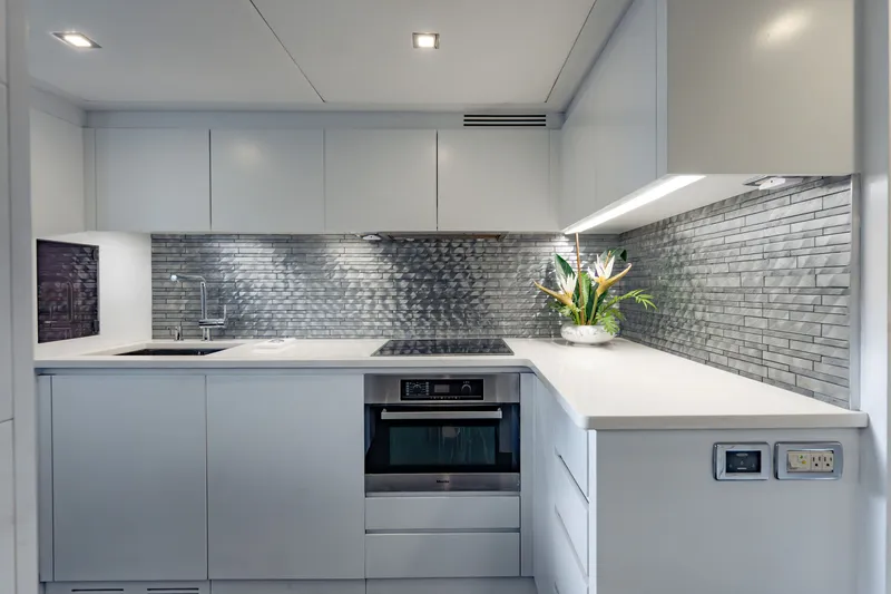 Slide: The Image of Modern kitchen in 2010 Pershing 80 yacht with sleek design and metallic backsplash. - 79