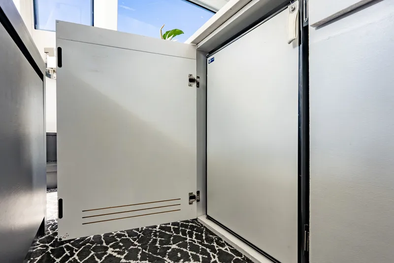 Slide: The Image of Open cabinet door on Pershing 80 yacht, 2010 model, with patterned carpet. - 40