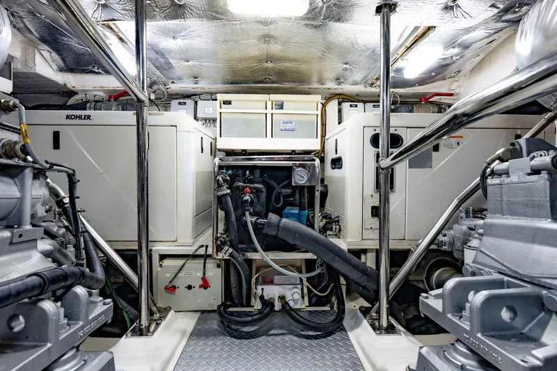 Slide: The Image of Engine room of a 2010 Pershing 80 yacht, featuring Kohler generators and advanced machinery. - 101