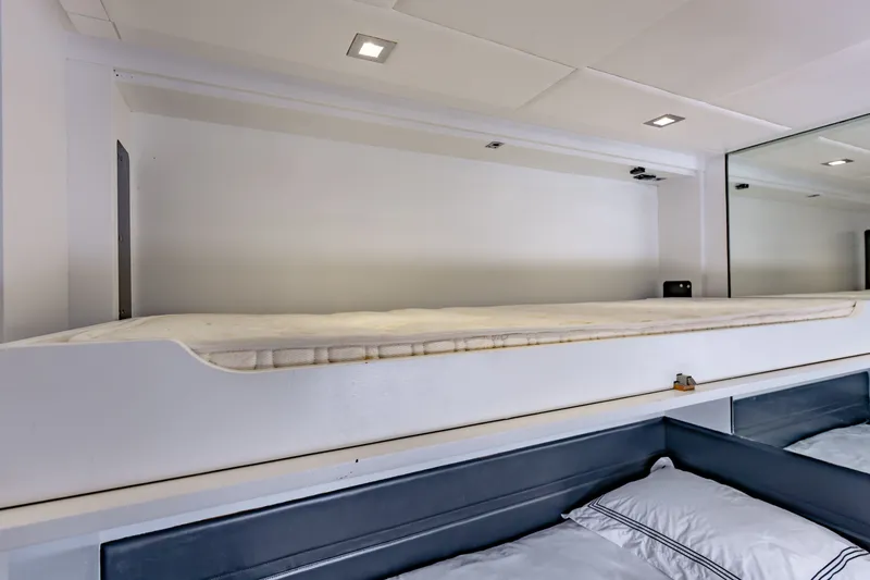 Slide: The Image of Interior of 2010 Pershing 80 yacht featuring a modern bunk bed setup. - 74