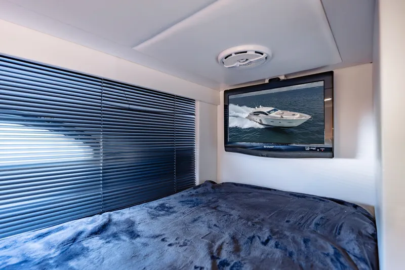 Slide: The Image of Cozy cabin interior of 2010 Pershing 80 yacht with TV and window blinds. - 87