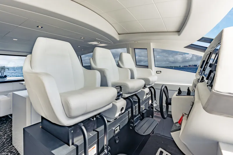 Slide: The Image of Interior of 2010 Pershing 80 yacht with modern helm seats and panoramic windows. - 46