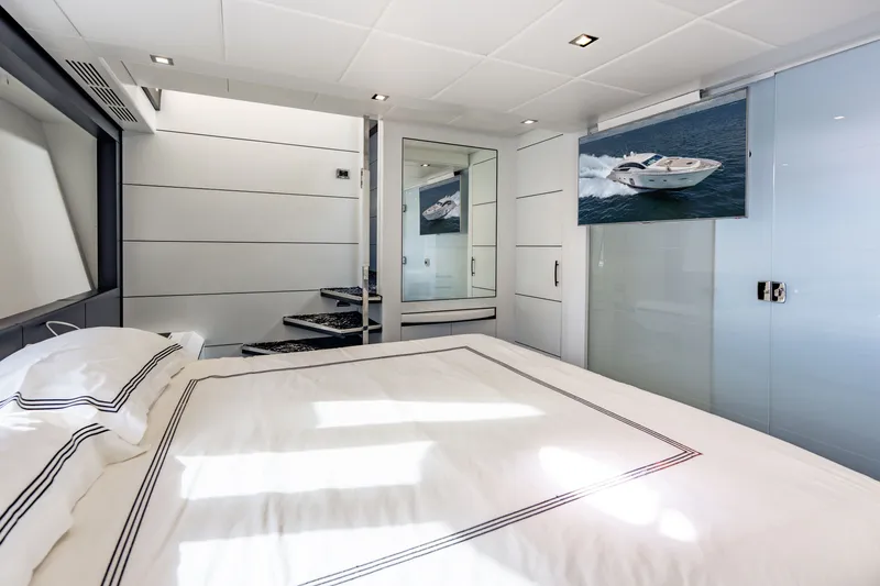 Slide: The Image of Luxurious bedroom interior on a 2010 Pershing 80 yacht, featuring modern design and elegant decor. - 53