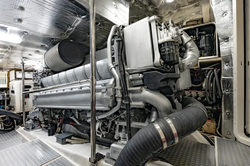 Slide: The Image of Engine room of a 2010 Pershing 80 yacht, showcasing a powerful marine engine. - 94