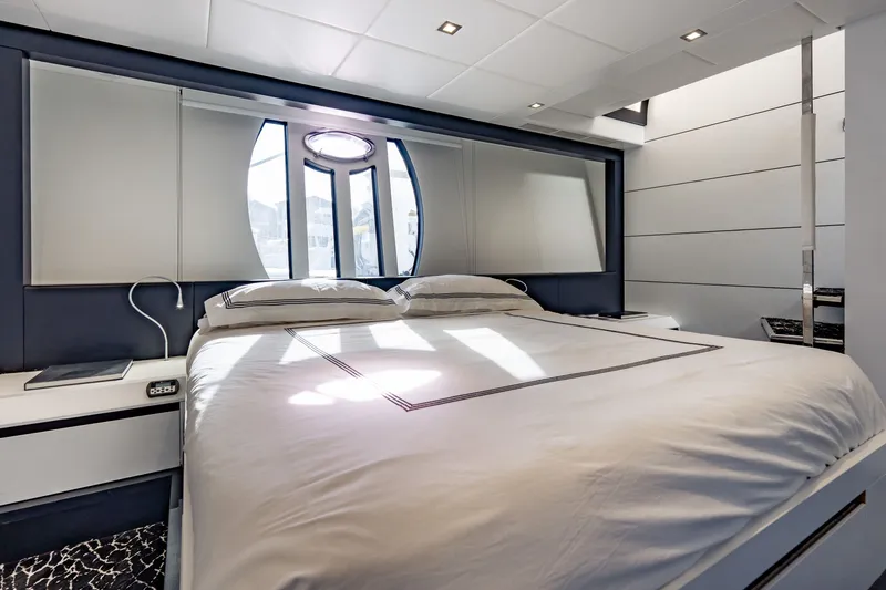 Slide: The Image of Luxurious bedroom interior on a 2010 Pershing 80 yacht, featuring modern design and elegant bedding. - 52