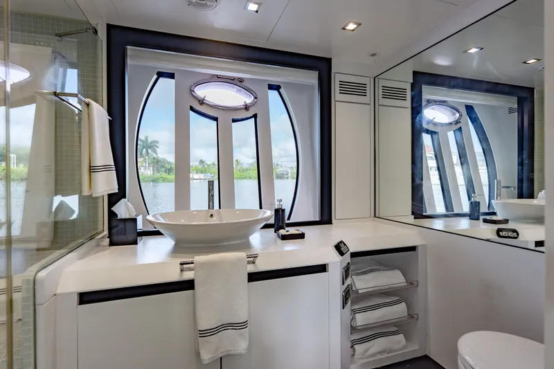 Slide: The Image of Luxurious bathroom interior on a 2010 Pershing 80 yacht, featuring modern fixtures and scenic window views. - 59