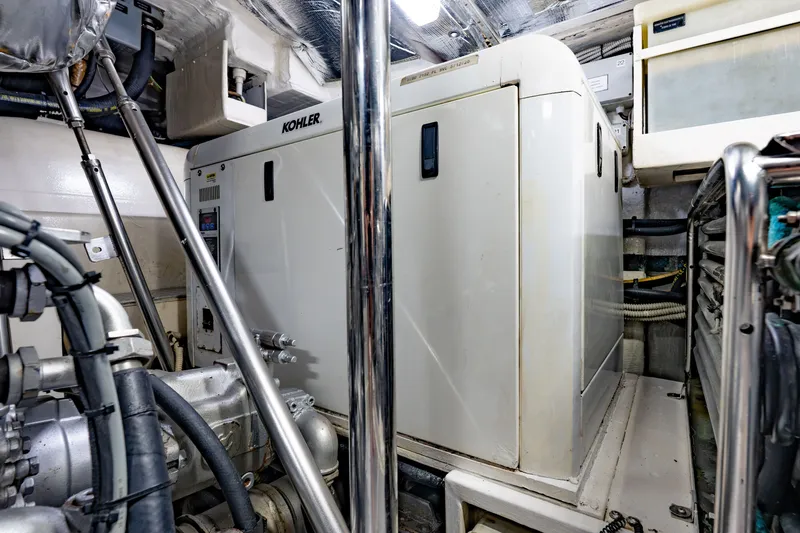 Slide: The Image of Engine room of 2010 Pershing 80 yacht featuring Kohler generator and mechanical components. - 105