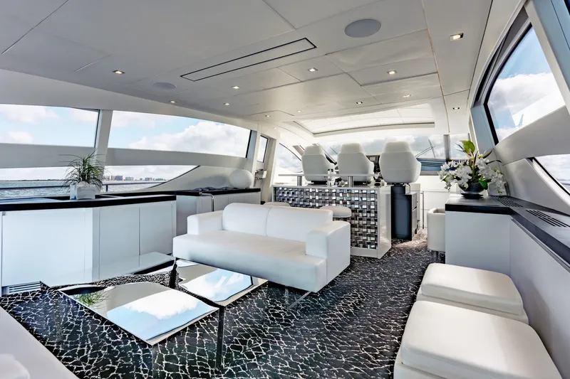 Slide: The Image of Luxurious interior of 2010 Pershing 80 yacht with modern white seating and panoramic windows. - 34