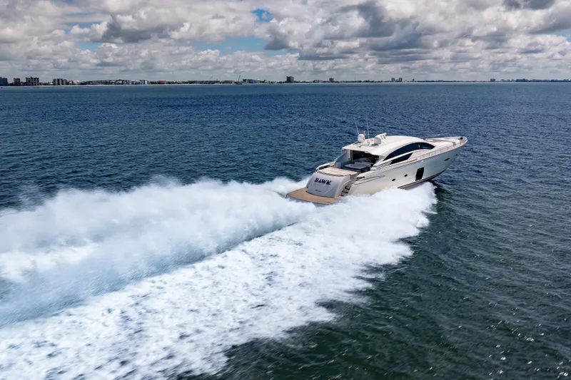 Slide: The Image of Luxurious 2010 Pershing 80 yacht cruising swiftly on open ocean under cloudy sky. - 6