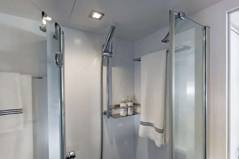 Slide: The Image of Modern shower area in 2010 Pershing 80 yacht, featuring glass doors and sleek fixtures. - 68