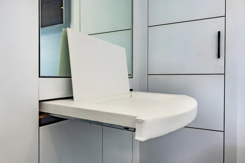 Slide: The Image of Foldable seat in a 2010 Pershing 80 yacht interior, showcasing sleek design and functionality. - 58