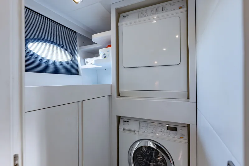 Slide: The Image of Laundry area on a 2010 Pershing 80 yacht with washer and dryer. - 89
