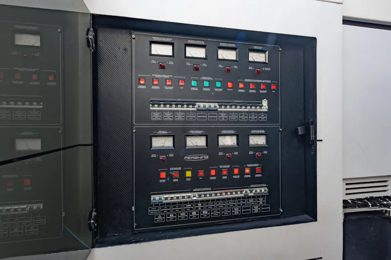 Slide: The Image of Control panel of a 2010 Pershing 80 yacht with gauges and switches. - 77