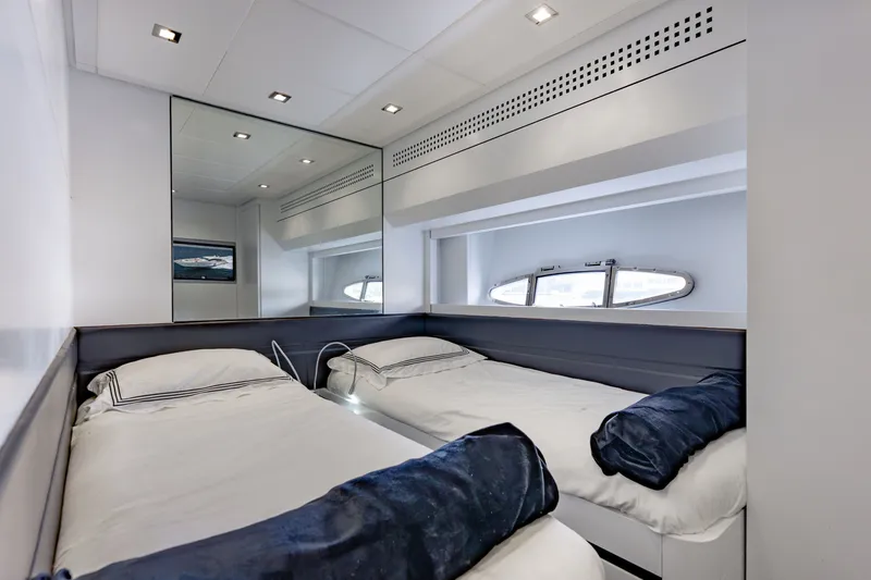 Slide: The Image of Luxurious twin cabin interior on 2010 Pershing 80 yacht with modern design and porthole window. - 69