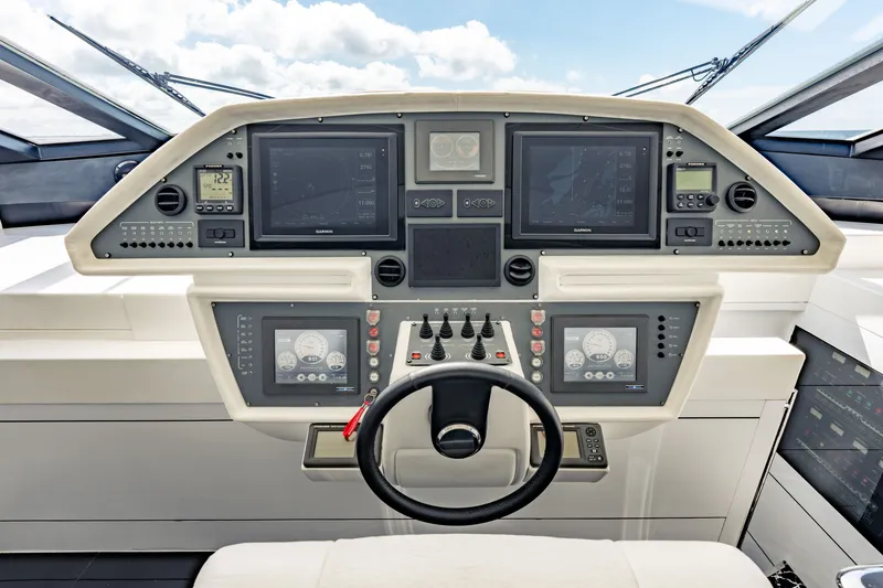 Slide: The Image of Cockpit of 2010 Pershing 80 yacht with advanced navigation systems and steering wheel. - 43