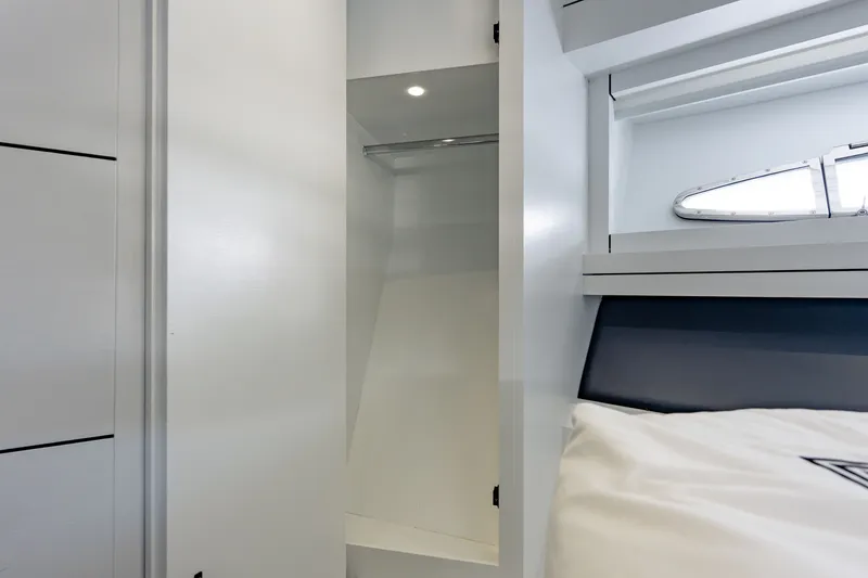 Slide: The Image of Interior of 2010 Pershing 80 yacht showing a sleek, modern closet and window. - 65
