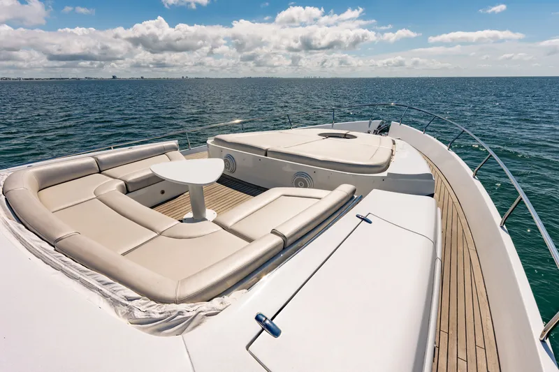 Slide: The Image of Luxurious 2010 Pershing 80 yacht deck with elegant seating, ocean view, and clear skies. - 30