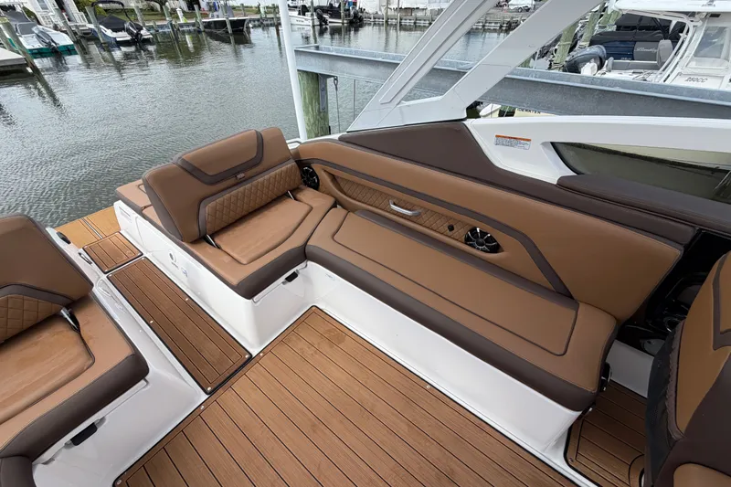 Slide: The Image of Luxurious seating on 2025 Yamaha Boats 275SD, featuring elegant brown upholstery and sleek design. - 14