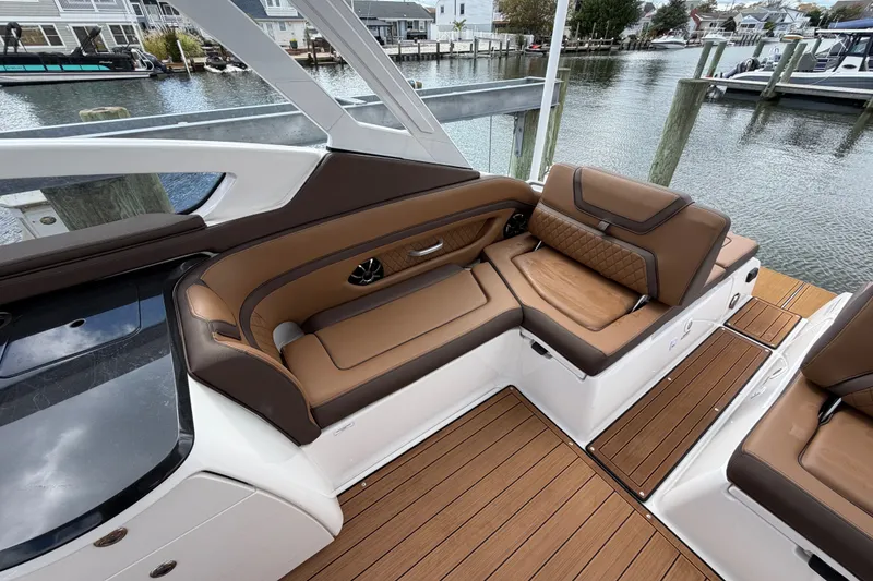 Slide: The Image of 2025 Yamaha Boats 275SD interior with luxurious brown seating and sleek design. - 13