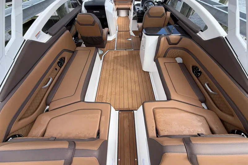Slide: The Image of 2025 Yamaha Boats 275SD interior with luxurious brown seating and sleek design. - 16
