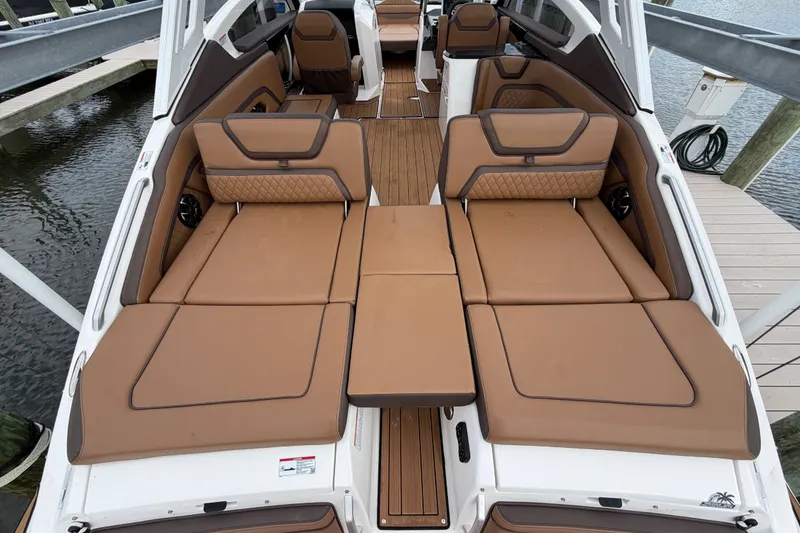 Slide: The Image of 2025 Yamaha Boats 275SD interior with luxurious tan seating and sleek design. - 28