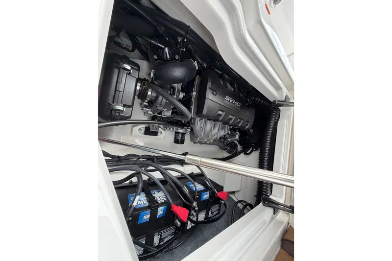 Slide: The Image of Engine compartment of 2025 Yamaha Boats 275SD, featuring SVHO engine and batteries. - 33