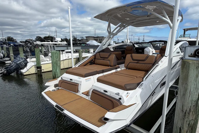 Slide: The Image of 2025 Yamaha Boats 275SD docked, showcasing luxurious seating and sleek design. - 7