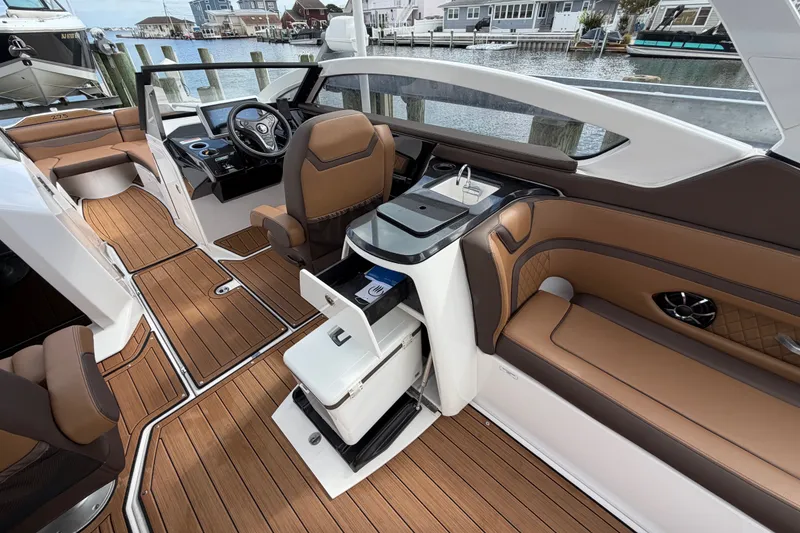 Slide: The Image of 2025 Yamaha Boats 275SD interior with luxurious seating, modern dashboard, and sleek design. - 18