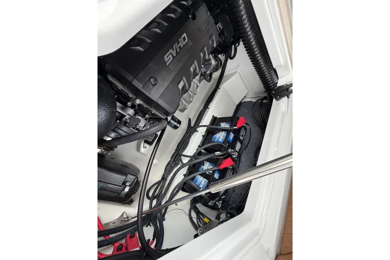 Slide: The Image of Engine compartment of 2025 Yamaha Boats 275SD, featuring SVHO engine and battery setup. - 34