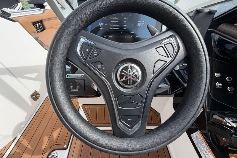Slide: The Image of Steering wheel of 2025 Yamaha Boats 275SD, featuring modern controls and dashboard display. - 23