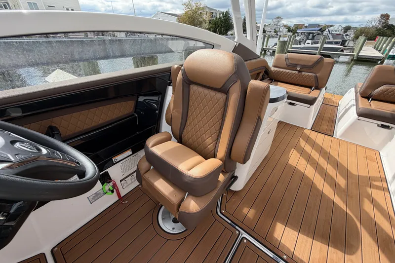 Slide: The Image of 2025 Yamaha Boats 275SD interior with luxurious brown leather seating and sleek design. - 20