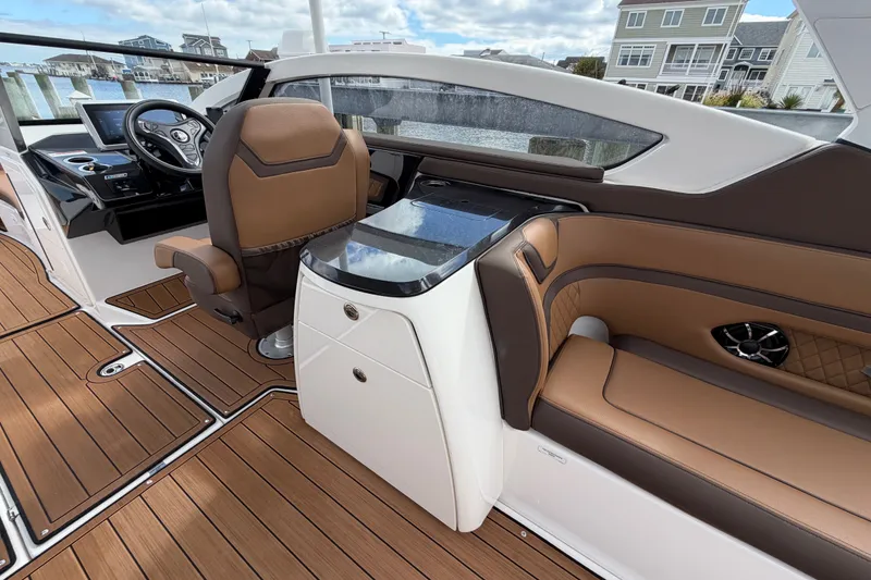 Slide: The Image of 2025 Yamaha Boats 275SD interior with brown leather seating and modern dashboard design. - 17