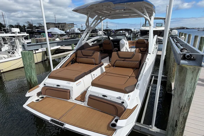 Slide: The Image of 2025 Yamaha Boats 275SD luxury motorboat docked, featuring spacious seating and sleek design. - 8