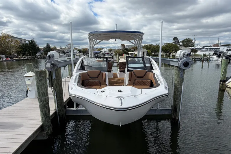 Slide: The Image of 2025 Yamaha Boats 275SD docked, showcasing sleek design and luxurious seating. - 5