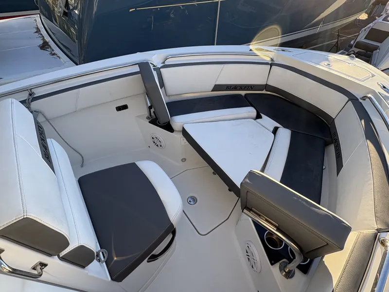 Slide: The Image of The image shows the cockpit of a 2019 Blackfin 212 CC with white and black seating. - 24