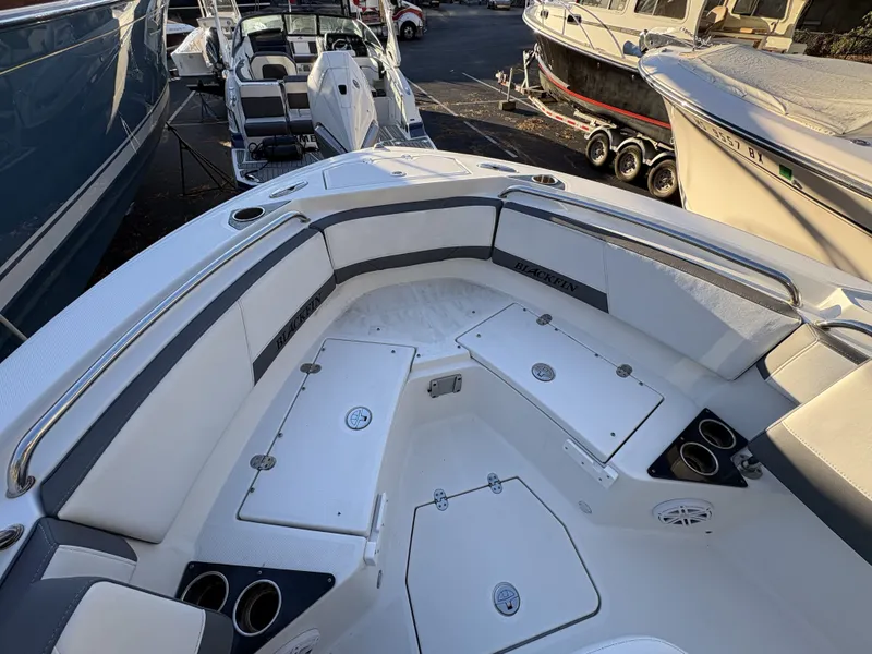 Slide: The Image of The image shows the bow area of a 2019 Blackfin 212 CC boat with seating and storage. - 19