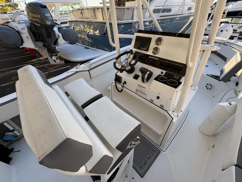 Slide: The Image of The image shows the cockpit of a 2019 Blackfin 212 CC boat with a helm console and seating. - 9