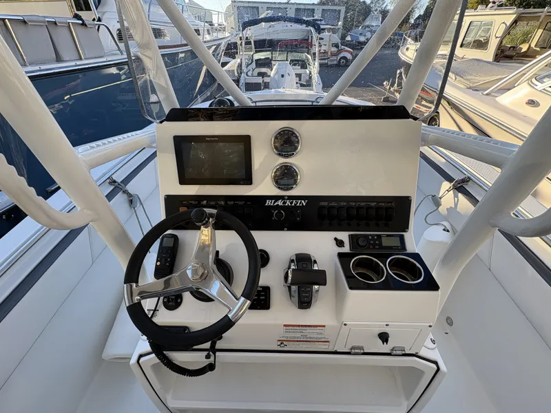 Slide: The Image of The image shows the helm of a Blackfin 212 CC boat with a steering wheel and instruments. - 12