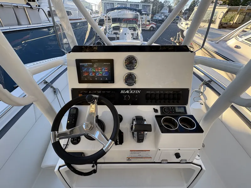 Slide: The Image of The image shows the helm of a 2019 Blackfin 212 CC boat with modern instruments. - 13