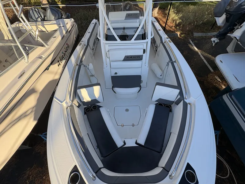 Slide: The Image of The image shows the cockpit of a 2019 Blackfin 212 CC boat with cushioned seating and storage. - 21