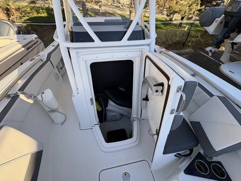 Slide: The Image of The image shows the cockpit of a 2019 Blackfin 212 CC with an open cabin door. - 25