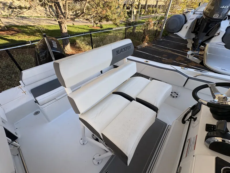 Slide: The Image of The image shows the cockpit of a 2019 Blackfin 212 CC with white cushioned seats. - 11
