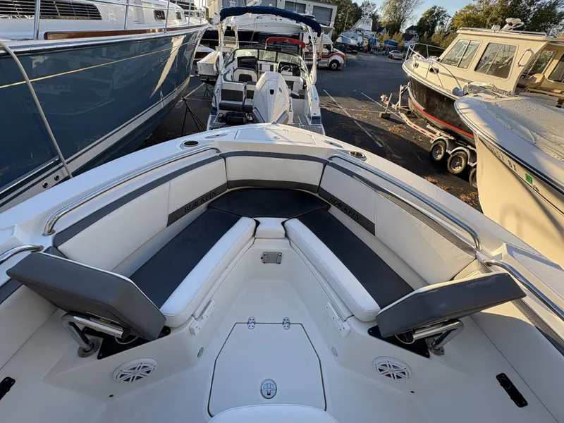 Slide: The Image of The image shows the bow of a 2019 Blackfin 212 CC with cushioned seating and speakers. - 22