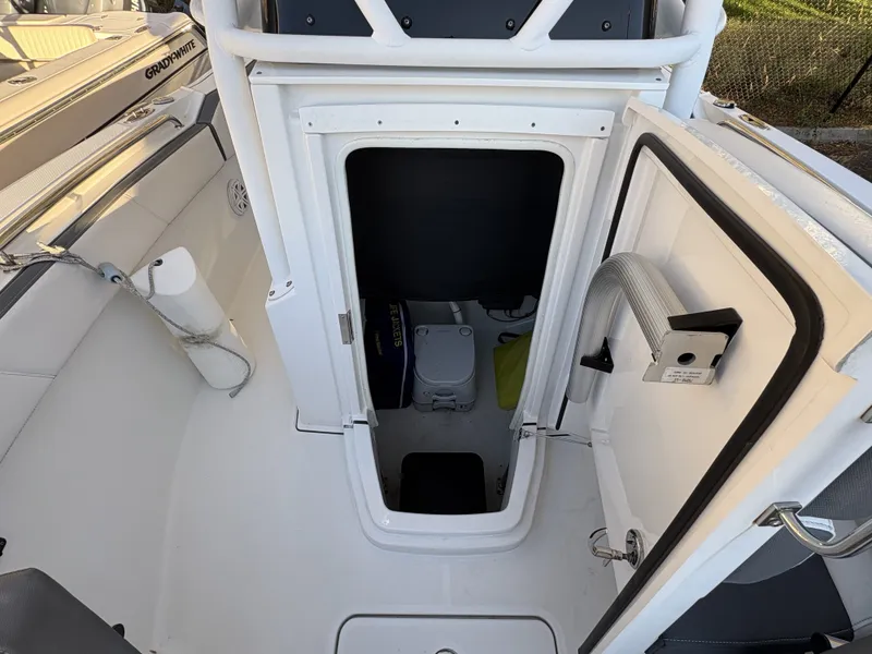 Slide: The Image of The image shows access to a small storage area or cabin on a 2019 Blackfin 212 CC boat. - 26
