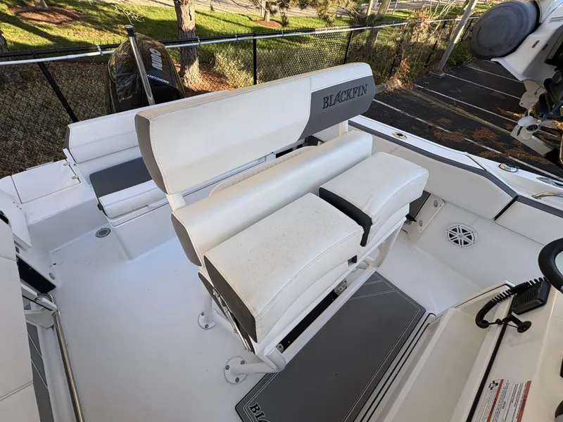 Slide: The Image of The image shows the cockpit of a 2019 Blackfin 212 CC boat with white seating. - 10