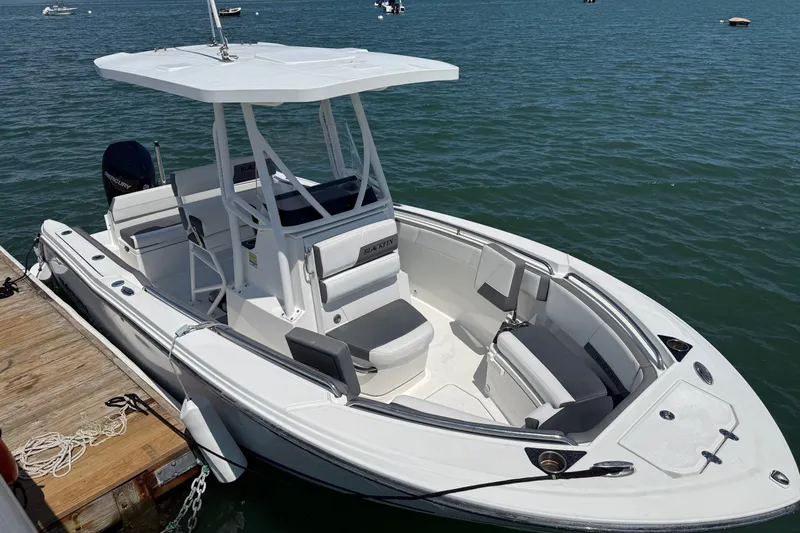 Slide: The Image of 2019 Blackfin 212 CC boat docked on calm water, featuring sleek design and spacious seating. - 3