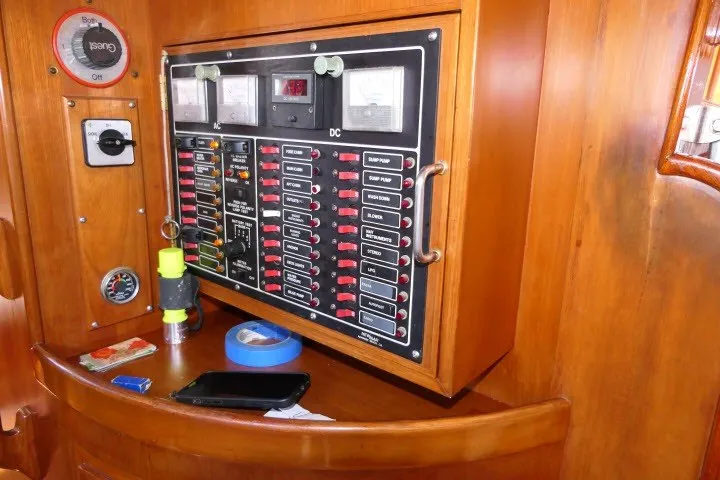Slide: The Image of Electrical panel on 1986 Tayana 52 Center Cockpit sailboat, featuring switches and gauges. - 19